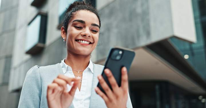 Hiring manager reviewing candidates in a recruiting firm's client room on her phone