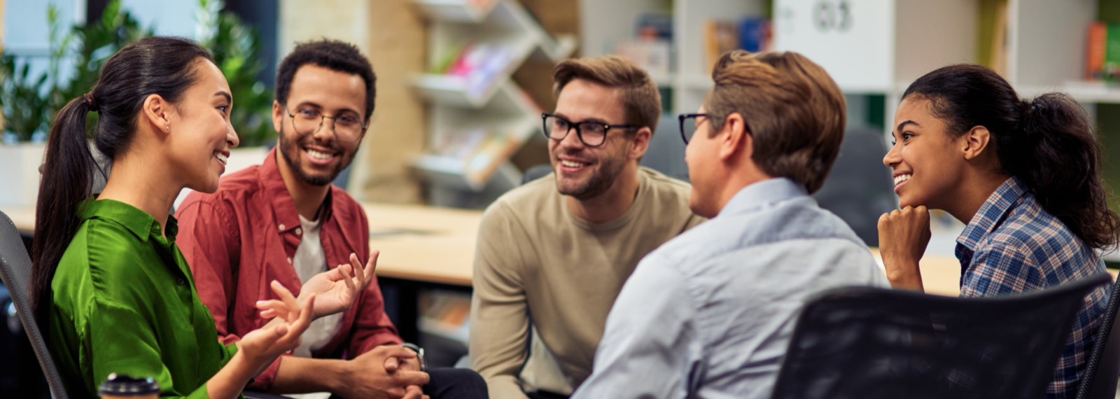 A small team laughing together around a table